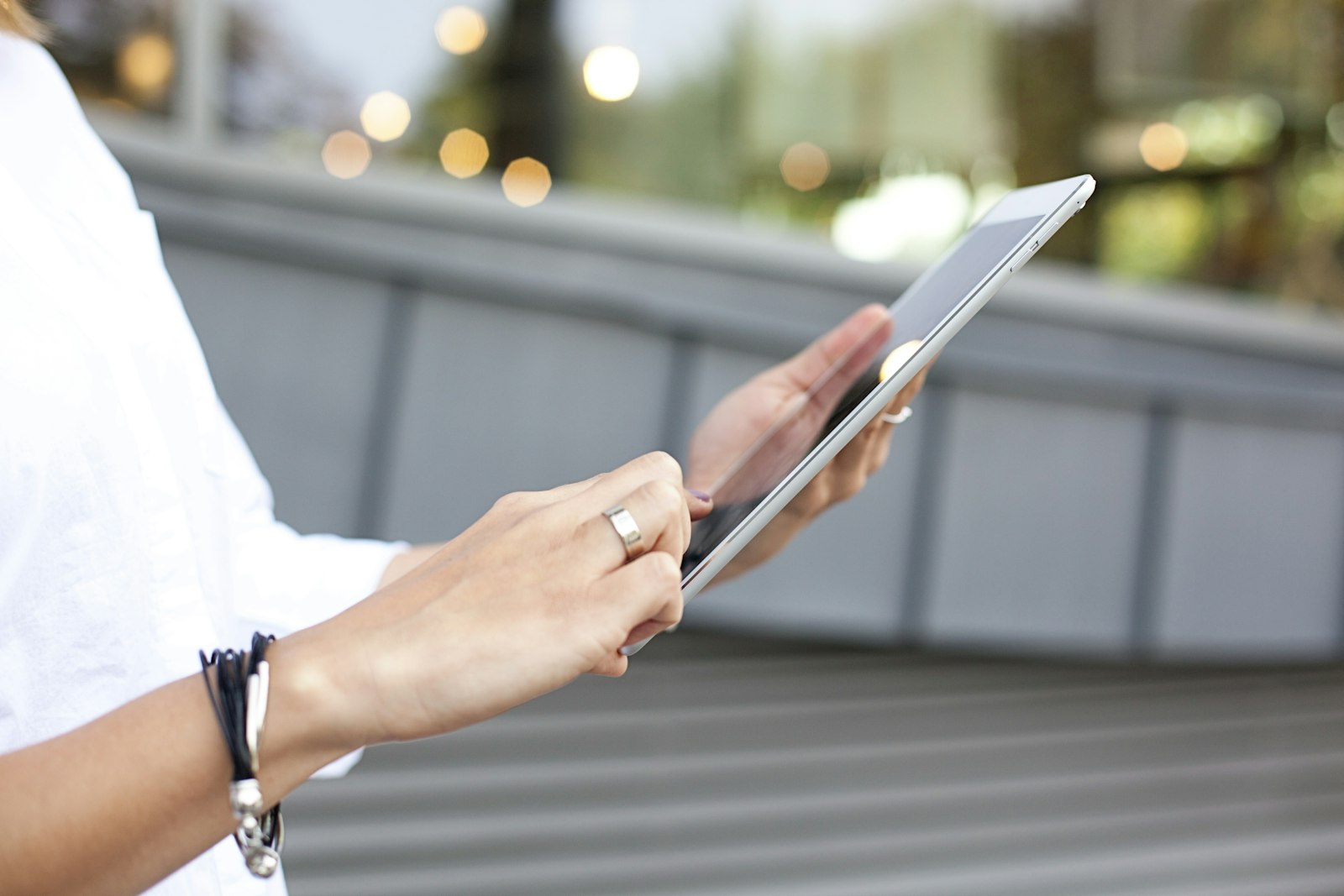 Person holding a tablet, illustrating this tablet buying guide comparing iPad, Android, and budget options