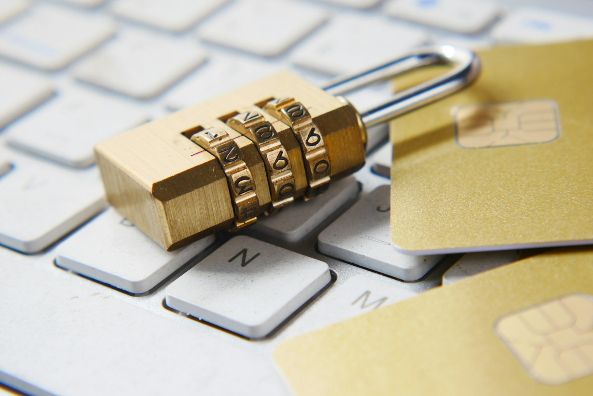 Golden padlock resting on a keyboard, representing data brokers and personal data privacy
