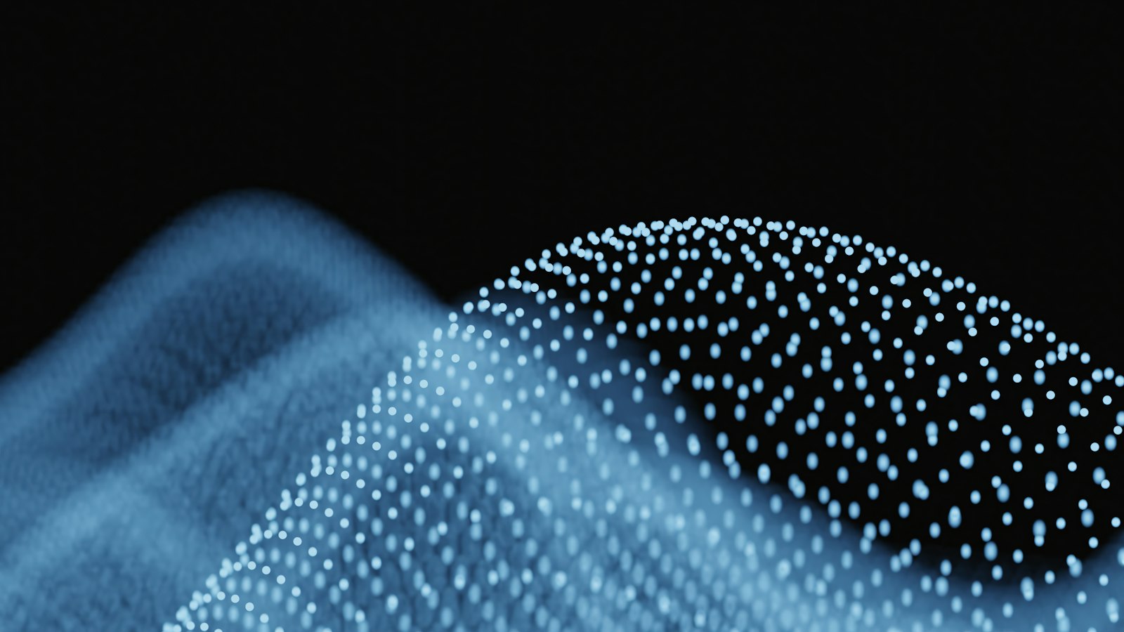 Abstract blue waves of glowing particles representing how AI reasoning models work