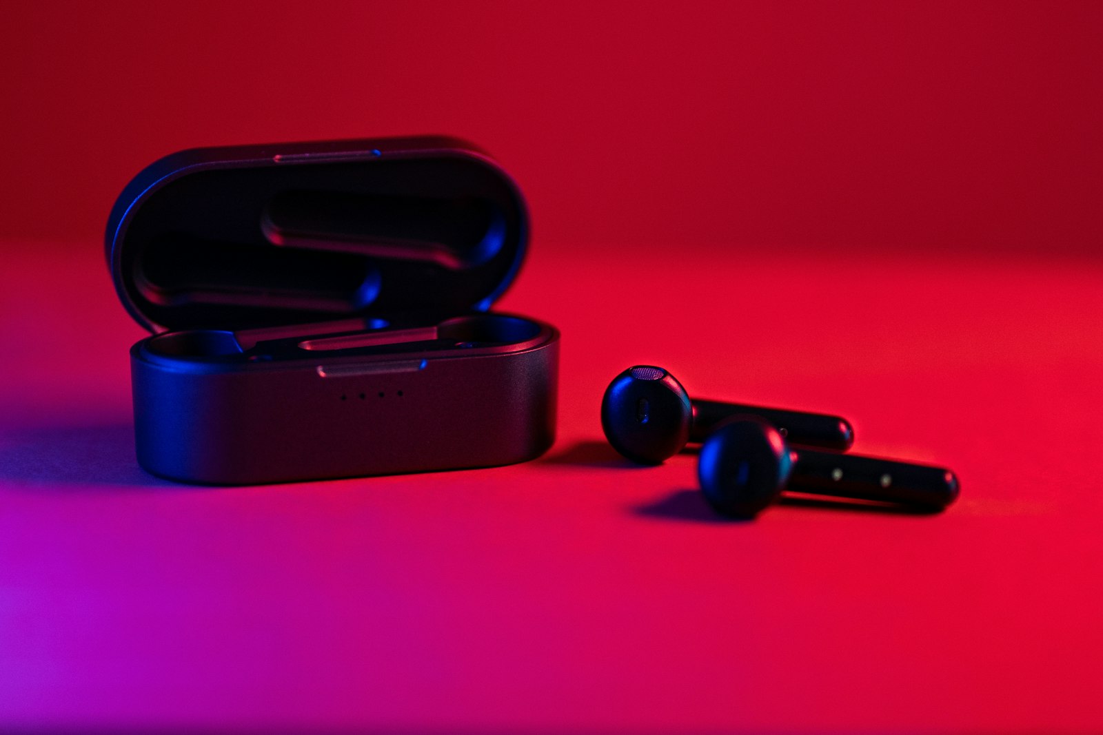 Black and blue Bluetooth earbuds illustrating Auracast and LE Audio